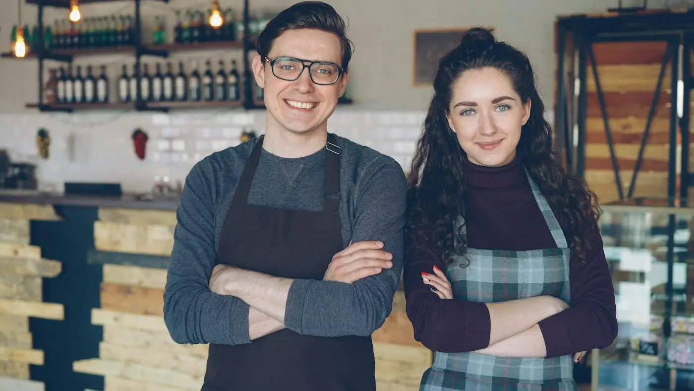 Two cafe owners standing in their shop