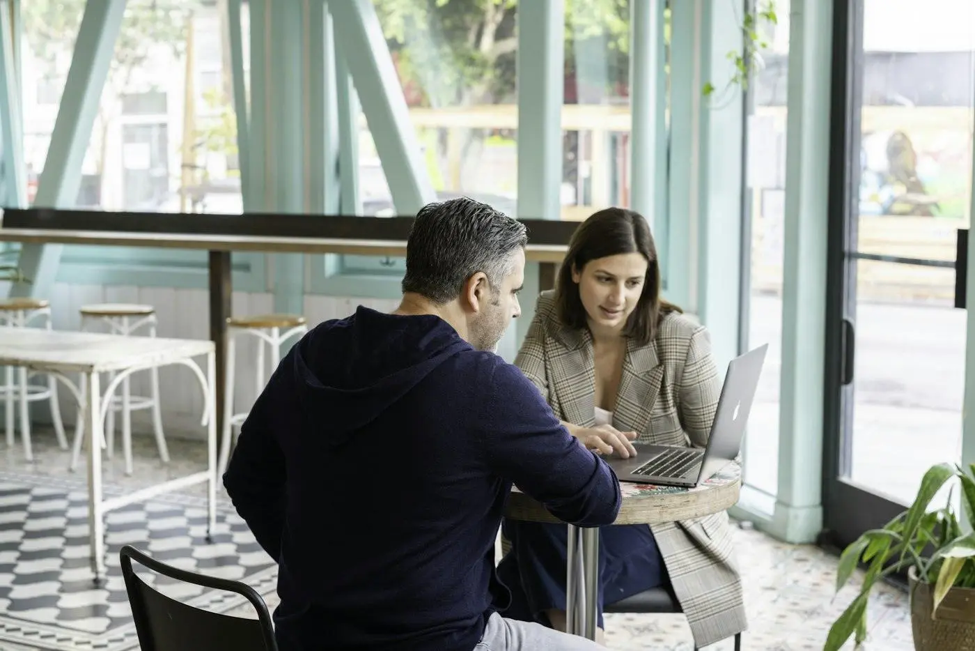Two people working together at a laptop